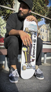 Alán with the FTC skateboard he designed for TOO $HORT